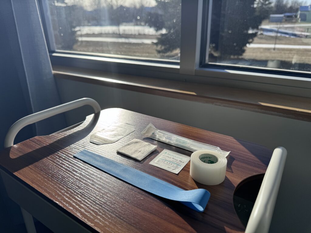 iv supplies set up on cart in front of window