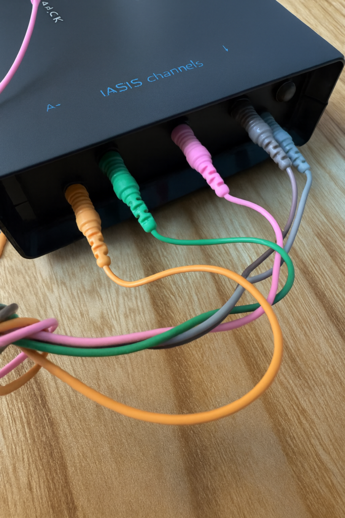 photo of neurofeedback device with eeg leads coming out